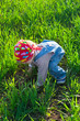 baby in the bandana on all fours in the field