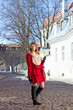 Photo: redhaired girl walking in medieval european town redhaired girl walking in medieval european town