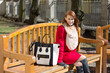 Photo: redhaired woman crossing sitting on the bench in park redhaired woman crossing sitting on the bench in park