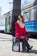 Photo: young beautiful woman waiting for train on the platform young beautiful woman waiting for train on the platform