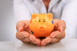 Piggybank and hands.