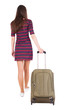 Photo: back view of walking woman with green suitcase back view of walking woman with green suitcase