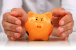 Piggybank and hands.