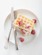 waffle with raspberry and icing sugar