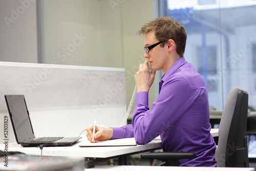 Photo: correct sitting position - man working in the office correct sitting position - man working in the office
