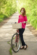 Foto: Girl with a bike in the countryside Girl with a bike in the countryside