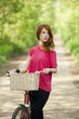 Girl with a bike in the countryside