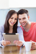 Smiling couple with digital tablet