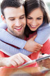 Smiling couple with digital tablet