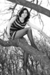A young girl in a dress and tights posing in spring wood