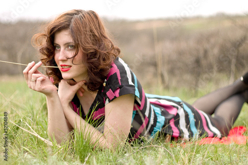 Photo: a young girl lying on the grass a young girl lying on the grass