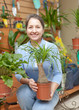 woman chooses Nolina at flower shop