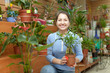 Photo: Female florist with ficus plant (Bonsai) Female florist with ficus plant (Bonsai)