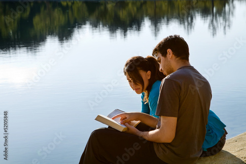 Photo: Couple Reading The Bible By A Lake Couple Reading The Bible By A Lake