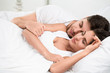 Young adult couple sleeping in bedroom