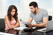 man upset after looking at card statement.