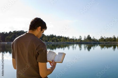 Photo: Man Reading Bible By Lake Man Reading Bible By Lake