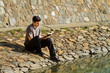 Man Reading Bible By Lake