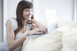 Smiling woman using her laptop