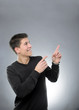 Smiling man pointing upward