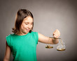 Foto: young girl holding a justice scale with money and smoke young girl holding a justice scale with money and smoke