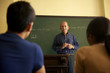 School people, professor talking to students during lesson in co