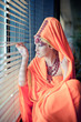 Girl in east clothes gazing out the window