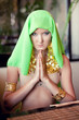 Portrait of a young beautiful woman in a prayer position