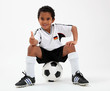 Dunkelhäutiger Junge mit Ball und Trikot im Deutschland-Look