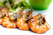delicious fried shrimp with salad in white plate.