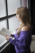 Young Woman in a Purple Shirt Reading a Book