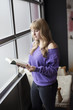 Young Woman in a Purple Shirt Reading a Book