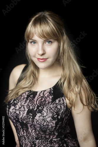 Photo: Young Woman with Beautiful Blue Eyes on Black Background Young Woman with Beautiful Blue Eyes on Black Background