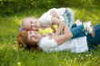 A young girl with mather on a green grass