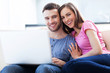 Photo: Couple on sofa with laptop Couple on sofa with laptop