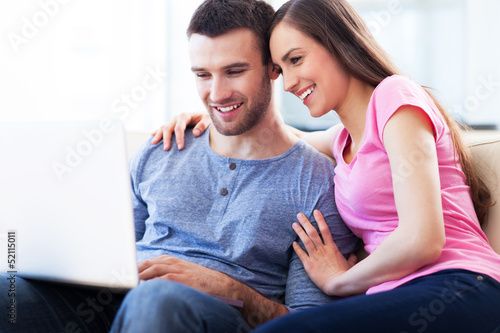 Photo: Couple on sofa with laptop Couple on sofa with laptop
