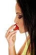 Teen girl eating strawberry.