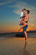 Photo: Couple on the beach at sunset Couple on the beach at sunset