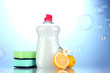 Dishwashing liquid with sponges and lemon with flowers