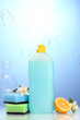 Dishwashing liquid with sponges and lemon with flowers