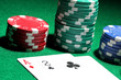 Cards and chips for poker on green table