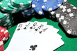 Cards and chips for poker on green table