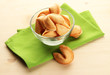 Fortune cookies in bowl, on wooden table