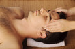 Photo: Man getting a face massage at spa Man getting a face massage at spa