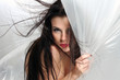 Afraid - Young woman hiding behind a plastic curtain