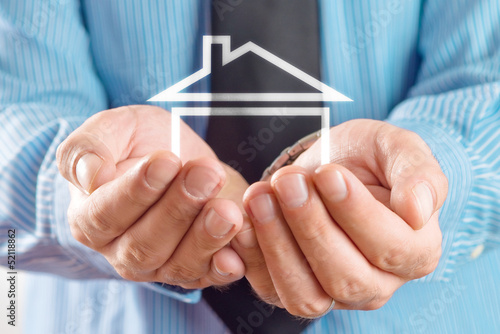 Photo: House in hands of businessman House in hands of businessman