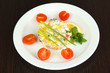 Small portion of food on big plate on wooden table