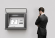 Photo: man looking at atm man looking at atm