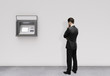 man looking at atm