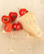 Piece of Parmesan cheese on wooden table close-up